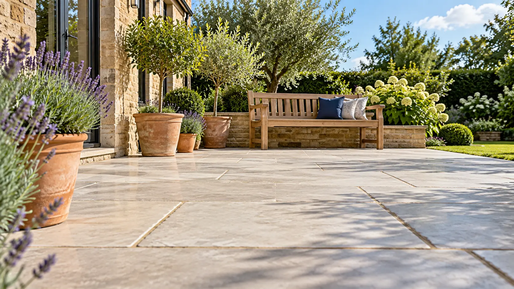 Illustrative clean limestone patio with a garden bench